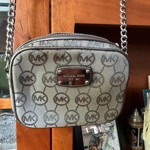 Michael Kors grey “MK” crossbody mini purse.